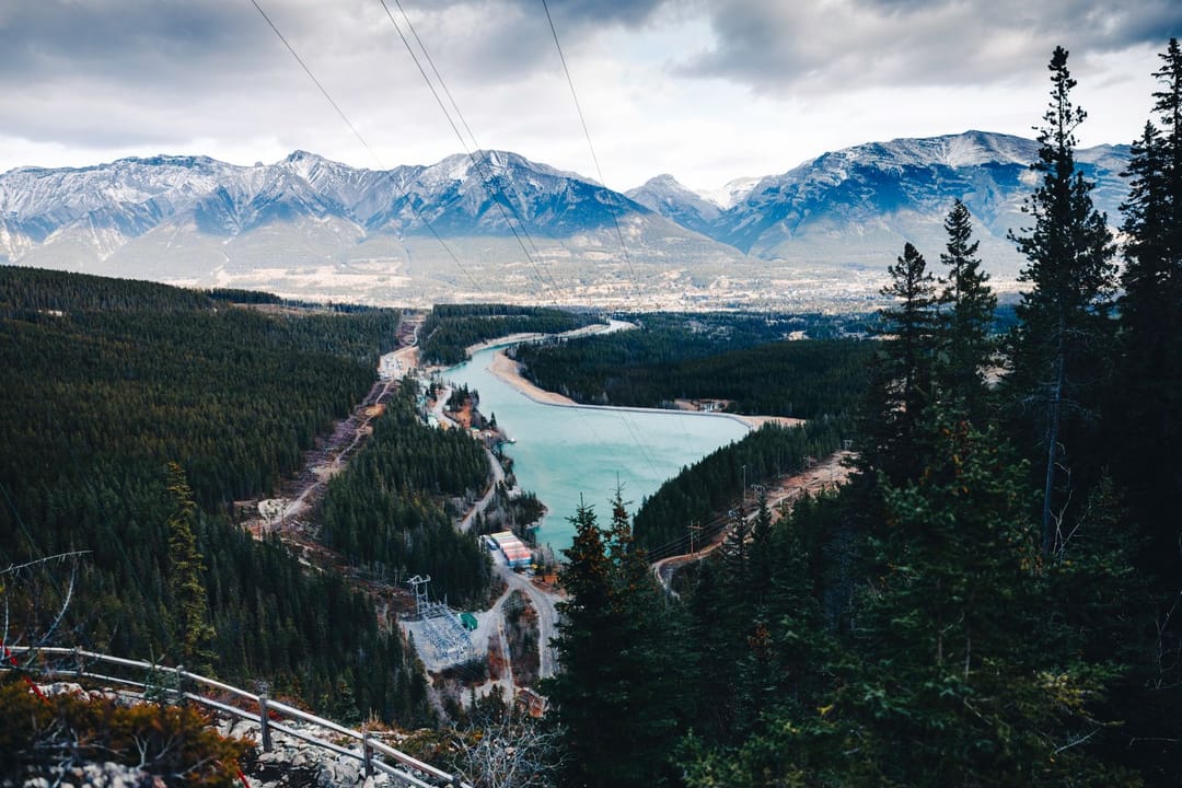 A wide British Columbia river valley winding between forested mountains